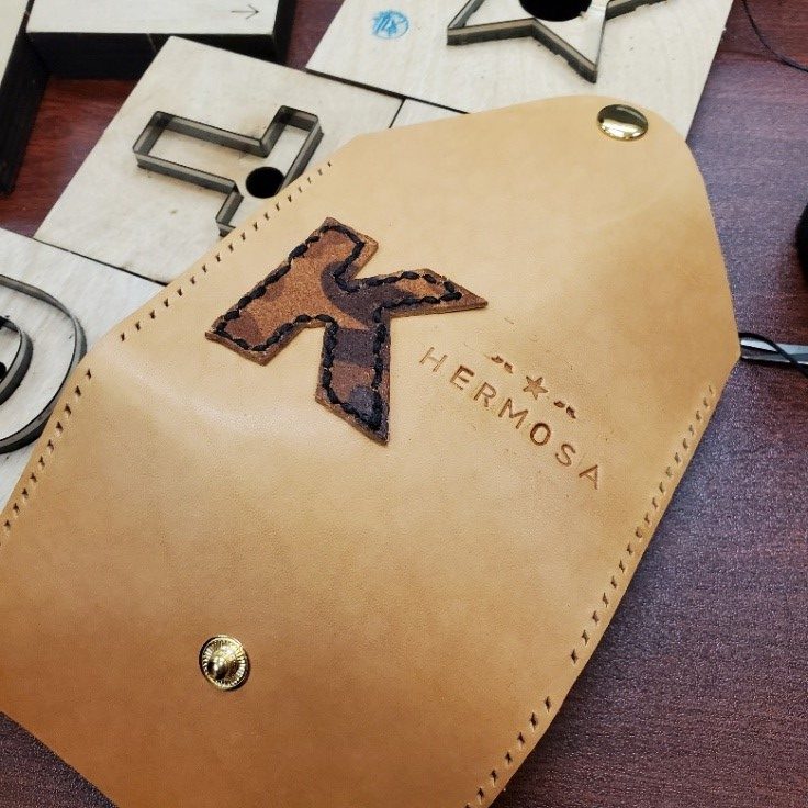 Handmade leather card holders from participants
